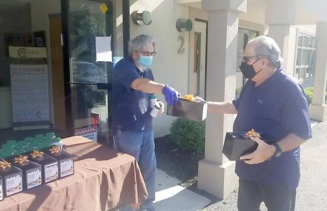 Steven Reich of Harriman picks us “Chocolate Challah for the Quarantined Soul” care packages from Chabad Cares volunteer and sponsor Dr. Ira Kanis of Monroe.