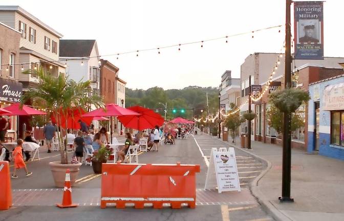 With the lights and the tables with the umbrellas, the Downtown Revitalization Committee created a unique dining experience in the heart of Monroe. Photo by William Dimmit.