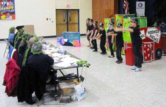 Performing their first-place, Division I, Problem 3 performance are Kajetan Leitner, Brad Pinkus, Jenna Walsh, Hayley Cowart, Alyssa Paverman, Emma McInerney and Brendan Fernandes.