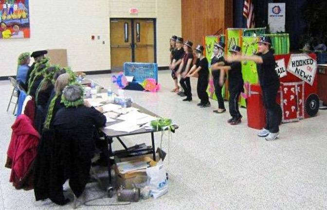 Performing their first-place, Division I, Problem 3 performance are Kajetan Leitner, Brad Pinkus, Jenna Walsh, Hayley Cowart, Alyssa Paverman, Emma McInerney and Brendan Fernandes.