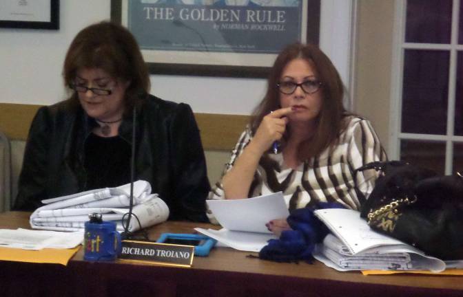 Photo by Nathan Mayberg By a 4-3 vote, Elisa Tutini, right, was elected chairwoman of the Monroe Town Planning Board. Kathy Troiano, the board's secretary, is to her left.