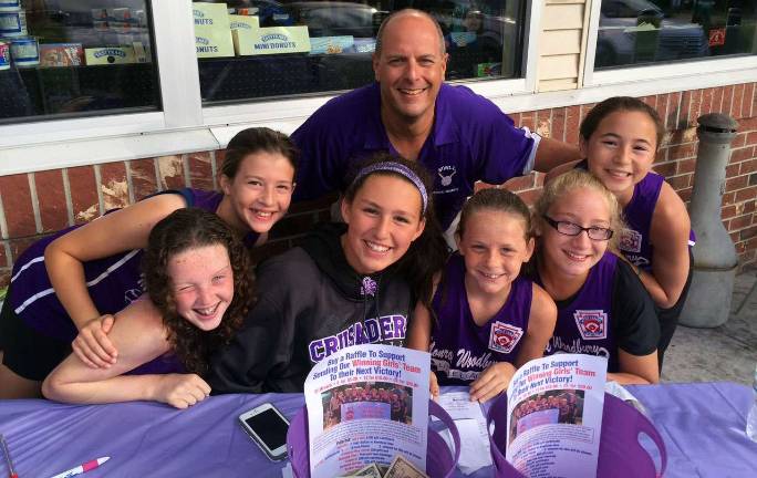 Monroe-Woodbury Little League Vice President for Softball Eric Dohman meets with Lindsay Sundheimer, left, Anna Paravati, Emma Lawson, Danielle Ryan, Hanah Armstrong and Brianna Roberts while they sold raffles at Quick Chek in Monroe this past Wednesday morning.