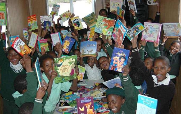 Happiness is can be seen in the faces of these South African second- and third-graders now that they have new books to read, courtesy of the efforts of the third-grade class at Tuxedo Park School.