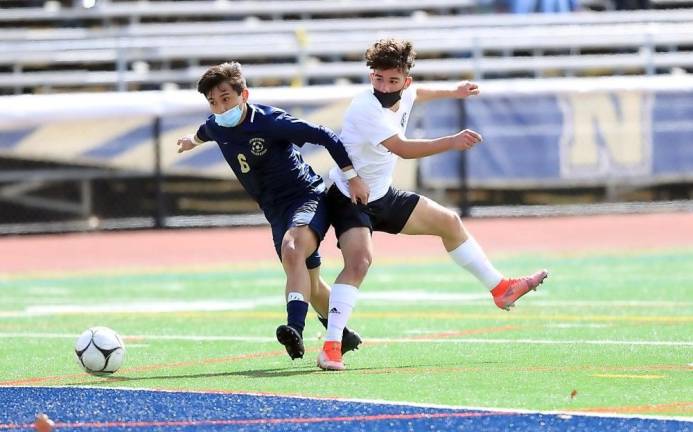 Crusader Ryan Guzman (in white) watches a shot go wide in the first half.