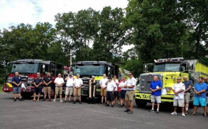 Chief Pat McKevitt (sixth from right) and fellow firefighters at the wet-down.