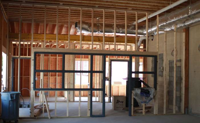In the newly built children's area, stud walls separate the programming and performance area from the collection room.