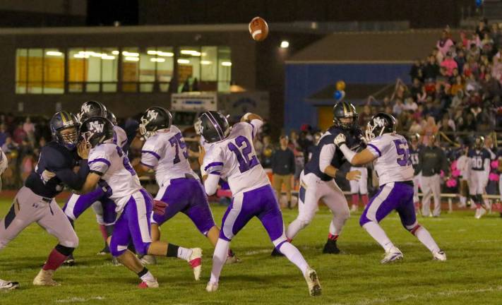 Photos by William Dimmit Steven Campione (#12) hits Jack Dembia with this 60-yard toughdown throw in the first quarter.