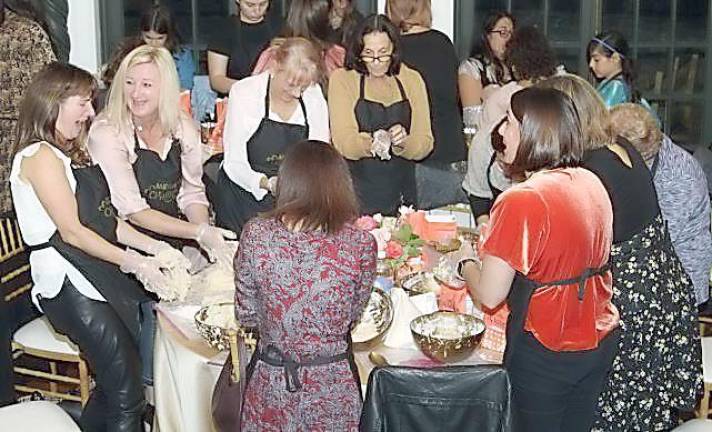 Everyone is getting into the spirit and kneading challah dough at Chabad’s Mega Challah Bake at the Rushmore Estate Ballroom.