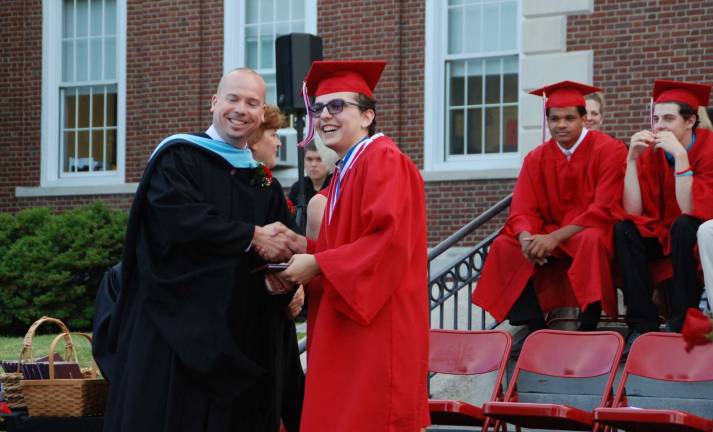 George F. Baker High School Principal Jason Schrammel congratulates Valedictorian Justin Alexander Luna.