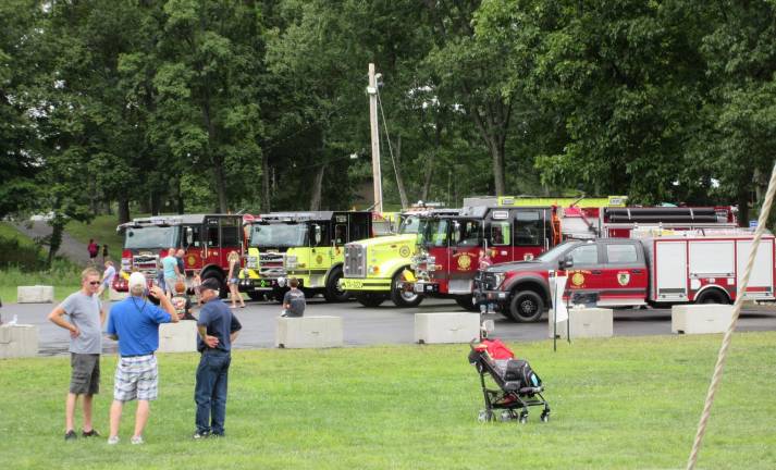 Chester’s new vehicles (from left): Engine 1, Engine 2, Tanker 2, Engine 3, Utility 3. Standing in front are past-Chiefs Jerry Murray and Steven Zoutman and Chief Joseph Verbet III.
