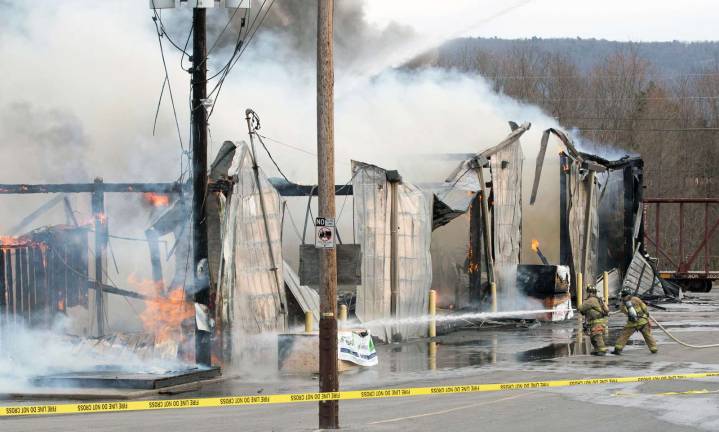Photo by Robert G. Breese On the scene Thursday of the fire that destroyed the Mid-State Lumber warehouse on Kings Highway.
