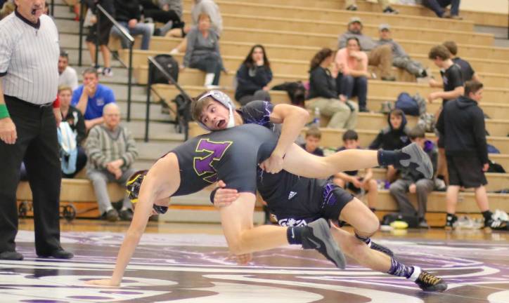 Dylan Earl (120 lbs.) reverses his Wildcat opponent before recording a pin.
