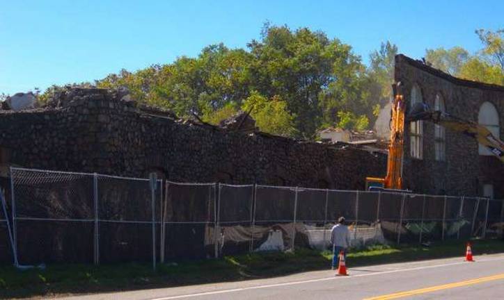 The demolition continues of the grand old building with just the lower front wall remaining this day.