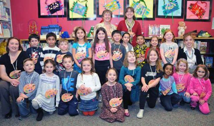 The participating Smith Clove Elementary School artists gather for group recognition during a reception in their honor. In the bottom row, from the left: Shane Lauterbach, Eryn Sammut, John McNeill, Monica Maxwell, Sophia Mantineo, Avlinn Jaskowski, Olivia Dial, Shreya Girish, Valerie Pedersen and Gabriella Zinko. Middle row: Art teacher Rebecca Walker, Daniel Connelly, James Nash, Robert Feil, Juliana Hashim, Aryana Lapointe-Bruning, Matthew Qu, Emily Taveras, Emmanuel Crespo Martinez, Olivia Rostkowski, Payton Grove and Assistant Principal Dr. Karin Morales. Back row: Principal Debra Turnquist and Jennifer Bradshaw, library director.