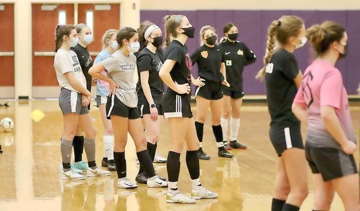 The Crusaders catch their breath as Coach Bill Mpasiakos explains their next drill.