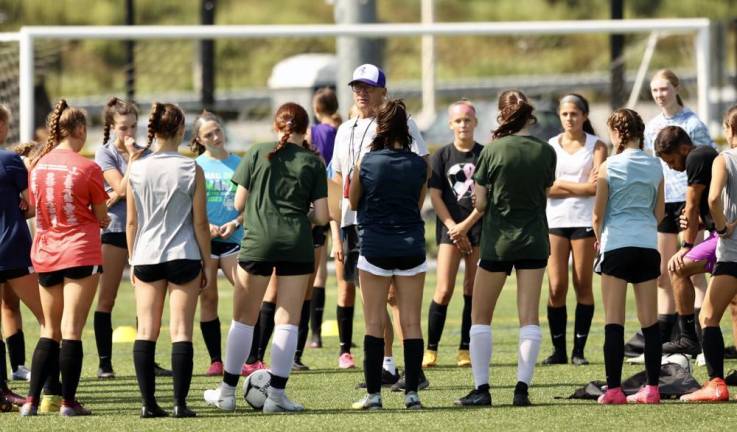 Bill Mpasiakos, the head coach of the Monroe-Woodbury Varsity Girls Soccer team, addresses the athletes before their workout last Tuesday morning, Aug. 22.
