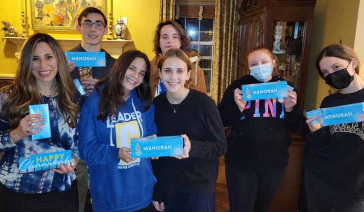 Chabad Teens Ariel Koyfman of Chester, Haley and Jordan Resti of Monroe, Ava Maier of Monroe, Isabella Hauck of Middletown and Dani Gold of Central Valley pictured with Chana Burston hold special CTeen menorahs they will use themselves or share with others during Chanukah. Chabad is also sending some CTeen menorah’s to CTeen alumni who are serving in the military. Senator James Skoufis will be making a special presentation to CTeen, in their important role as ambassadors of lights, at the Firetruck Gelt Drop and Menorah Lighting event on Monday in Monroe.