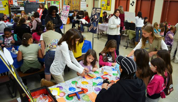 Cadette Troop 142 leads younger scouts in their troop&#xed;s &#xec;Create-a-Card&#xee; Silver Award project.