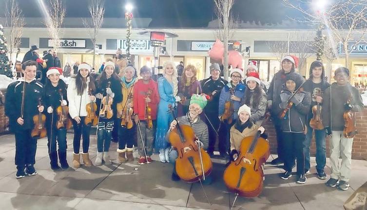 A month of music begins: Allegro members posing with the Disney’s stars from Frozen II at the Woodbury Common Christmas Tree Lighting on Dec. 6.