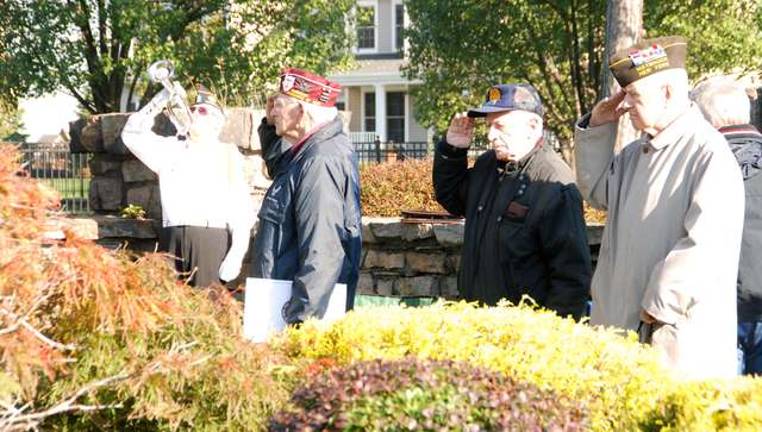 Harvey Horn, Sidney Tendler and state Sen. William J. Larkin Jr. salute during the playing of &quot;Taps.&quot;