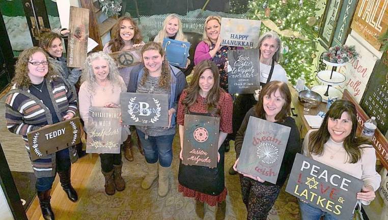 Jessica Cohn of Warwick, Yasmine Kalkstein of Monroe, Karen Benezra of Monroe, Zahavah Callan of Goshen, Becky Benezra of Monroe, Svetlana Askenazy of Highland Mills, Chana Burston, Serach Callan of Goshen, Dara Ellen of Warwick, Elyse Stock of Highland Mills and Lori Robertson of Cornwall and display the Chanukah decorations they created.