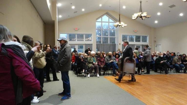 Crowds turned out for the April 18 public hearing about Neil Gold’s dinosaur park, filling the room and standing when there were no available seats left. Photo: Sharon Scheer