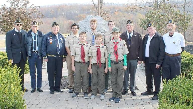 Pictured at the Heroes’ Memorial with the Boy Scouts are, from left to right: Ralph Caruso, Don Blair, Bill Doyle, Bob Cotter, Ken Smith and Fred Ungerer. The scouts (in the center of the photo), members of Woodbury Troop 4, included (top row): Ricky Quiles (16), Brandon Gibson (17), Lars Poutsma (13); and (infront): Daniel Askenazy (13), Aiden Askenazy (11) and Liam McMahon (12).