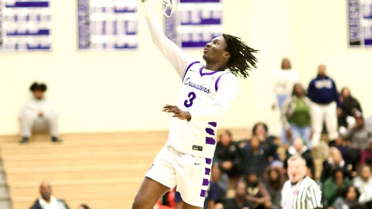 Crusader Fabrice Ndja drives to the basket in the first quarter against Newburgh.