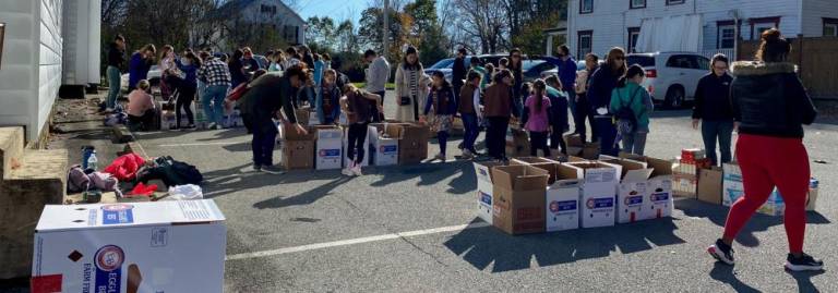 On Saturday, November 6, the Girl Scouts and numerous community volunteers came together and packed the dry goods for the first November distribution and the Thanksgiving distribution. In all, they packed close to 200 boxes. Provided photo.