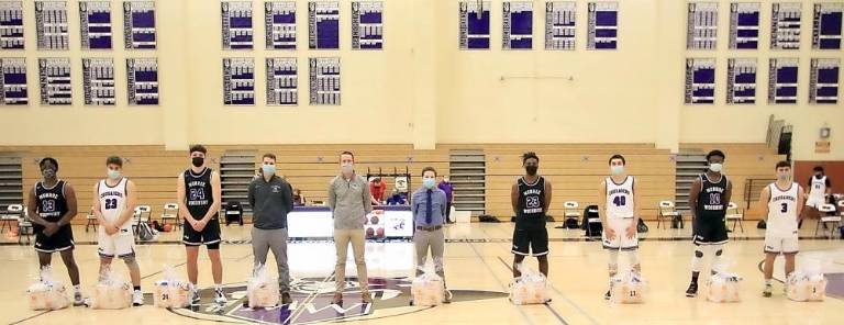 Pictured from left to right are the seniors on the Monroe-Woodbury Varsity Boys Basketball team: Aaron Paul, Jared Fernandez, Tom Concannon, Justin Taunton, Head Coach Jim Hahn, Jon Pelcin, Cam Adams, Jason Dimura, Samuel Omitiran and Gavin Reich.