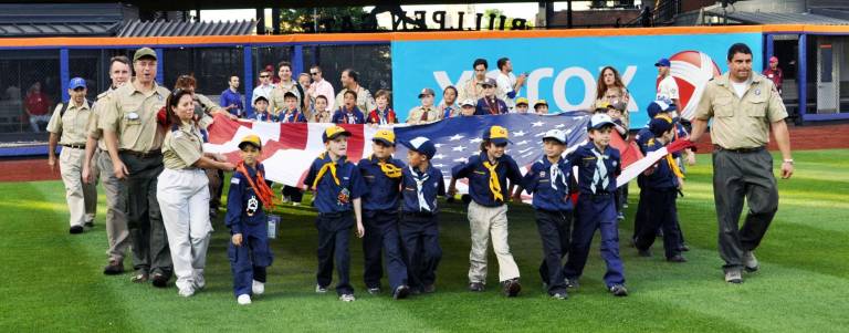 Entering the stadium&iacute;s field are Cub Scout Pack 340, Boy Scout Troop 340 and other scouts from the tri-state area.