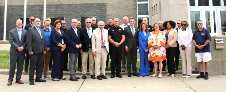 Local legislators, law enforcement leaders and others gather at the Orange County Sheriff’s Office to announce the extension of death gamble benefits.