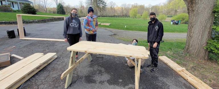 Chabad teens construct a picnic table at the Pardess Chabad Farm.