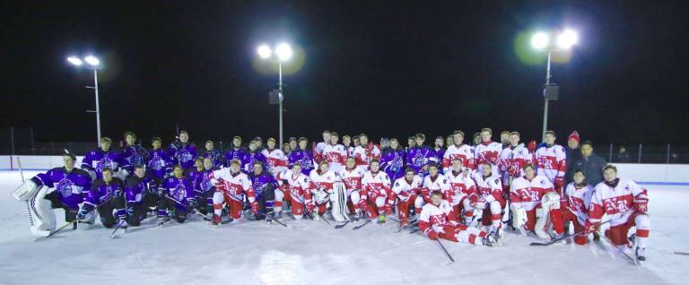 All for a good cause: the Crusaders and Red Raiders pose for a photo after the game.
