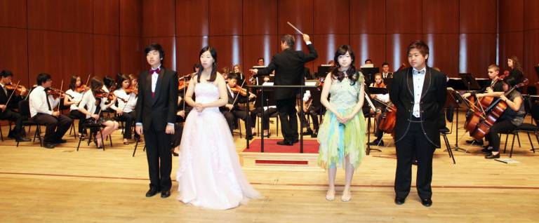Members of the youth symphony performed with four middle school Korean student singers who are studying opera.