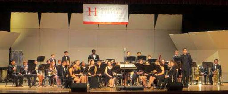 The Monroe-Woodbury Wind Ensemble prepares to perform for the WorldStrides Heritage Performance Festival. The group received Gold.