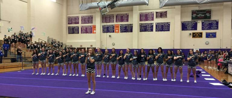 M-W&#xfe;&#xc4;&#xf4;s Varsity Cheerleaders support Ashley Meese as she sings the National Anthem.