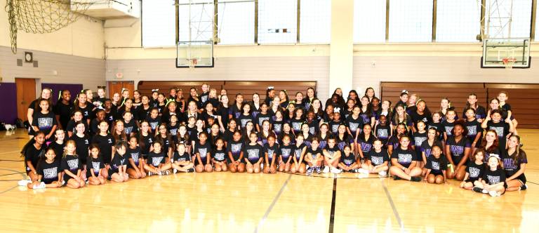 The Crusader varsity and JV cheer teams with their protégés.