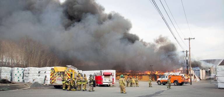 Photo by Robert G. Breese On the scene Thursday of the fire that destroyed the Mid-State Lumber warehouse on Kings Highway.