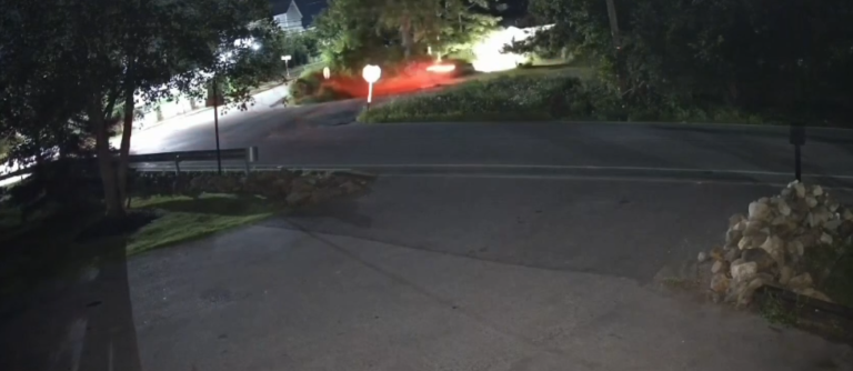 A screenshot of surveillance video shows a car crashing into a house in Monroe in the early mornings hours of July 26.