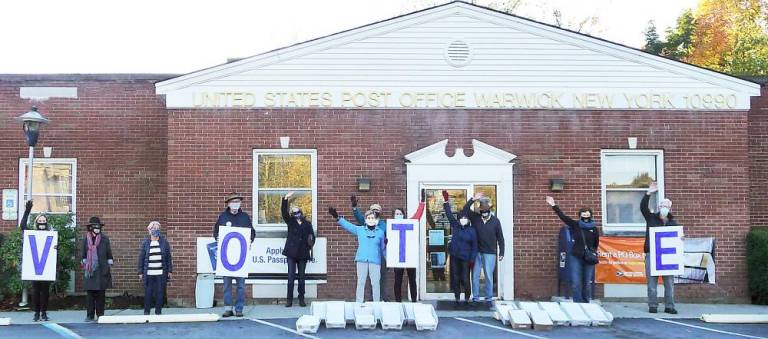 Outside of the Post Office in Warwick on Oct, 17, members of Indivisible Hudson Valley NY, participated in the Vote Forward National Send Off Day by mailing more then 8,000 personalized letters to voters across the country. Photo provided by Patty Cook.