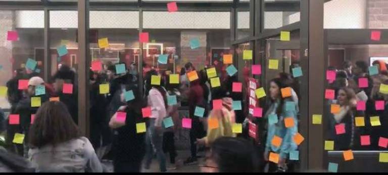 Post-It notes written by participating students were left on glass walls in the school&#x2019;s main lobby to explain to why they participated.