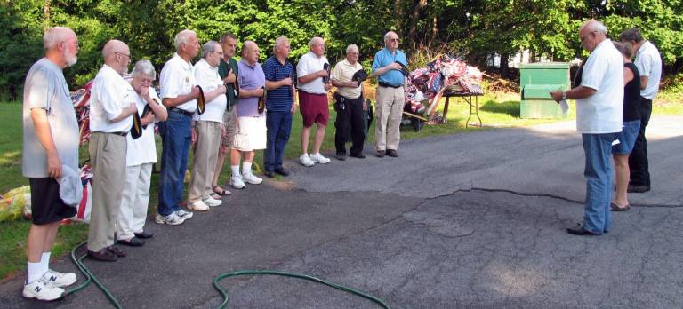 After a brief ceremony, during which Post Commander Frank Gilner explained how the flags have served the country and why they are now unserviceable, Adjutant Fred Houston read a short prayer as members uncovered.
