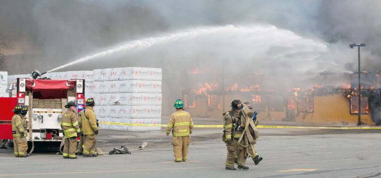 Photo by Robert G. Breese On the scene Thursday of the fire that destroyed the Mid-State Lumber warehouse on Kings Highway.