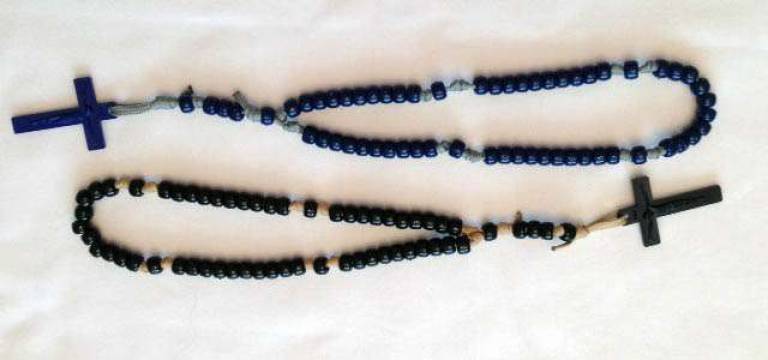 The handmade rosaries are made of parachute cord, with dark plastic beads and crucifix, and have no metal parts to reflect light or make noise in the field.
