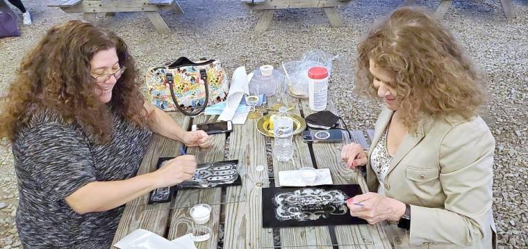Pictured from left to right: Stephanie Melillo and Carla Maier, both of Monroe, enjoy learning the art of glass etching at Chabad’s Jewish Women’s Circle.