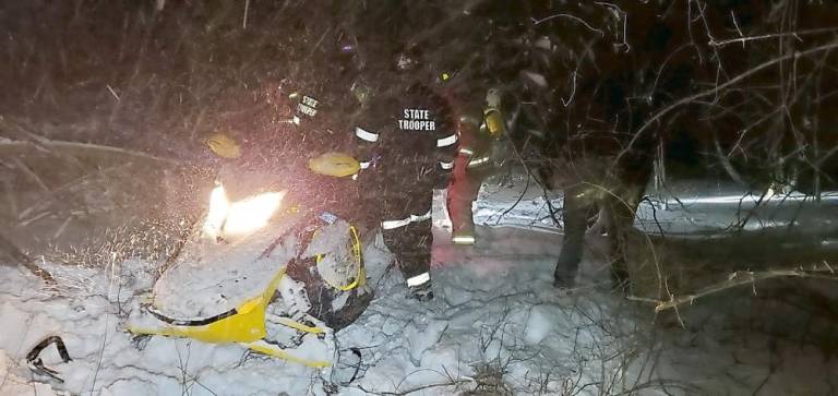 Rescuers used a Troop F snowmobile unit to transport the second of two men whose snowmobile broke through the ice on the Goshen Reservoir to an ambulance which then took him to Garnet Medical Center in the Town of Wallkill. Photo provided by the New York State Police.