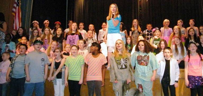 Julia Wilkinson sings &#xec;It&#xed;s Always a Good Time at Pine Tree&#xee; with talent show participants joining in.
