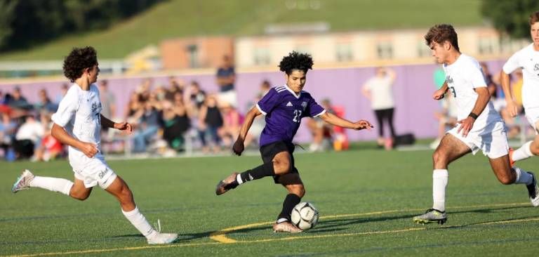 Carlos Perez-Turcios (#27) tries to get a shot through the the Plainsmen defense.