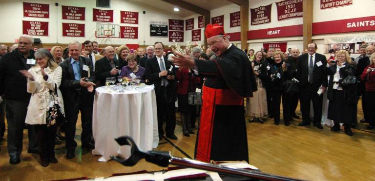 Photo by Ed Bailey Cardinal Timothy Dolan shares his thanks to a group of musicians from Monroe-Woodbury High School who played during the archbishop's reception with the faithful at Sacred Heart Parish in Monroe.